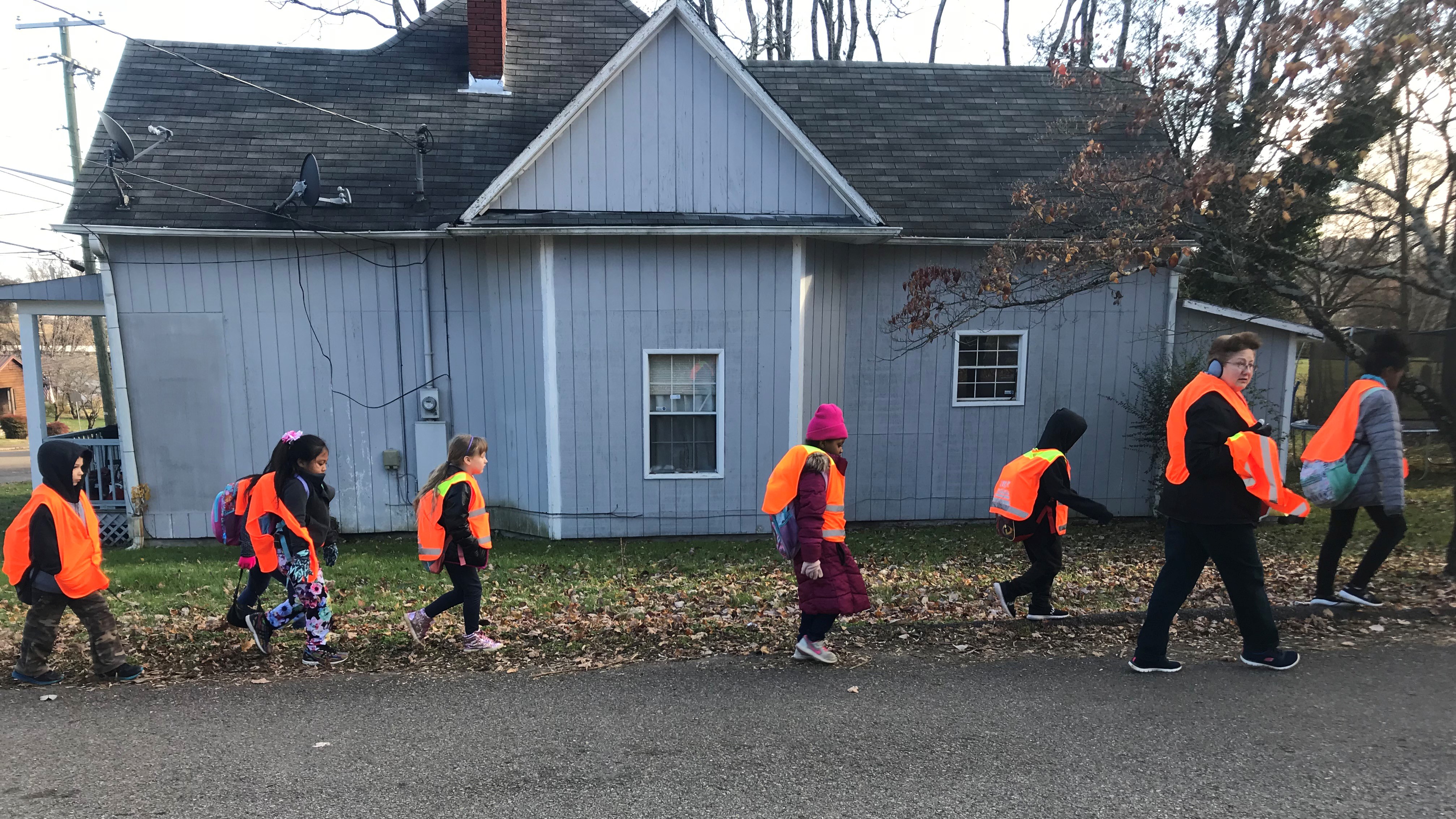 Teaching assistant Cindy Poland leads students from West View Elementary School as they participate in the Walking School Bus program.. 